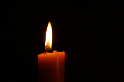 candle burning in darkness